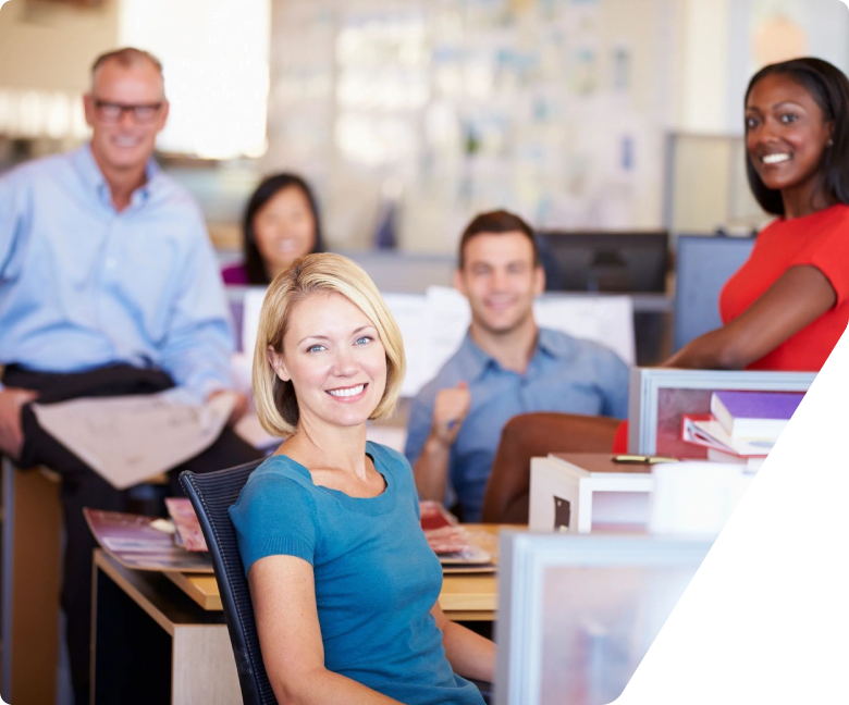 A group of people sitting at tables in an office.